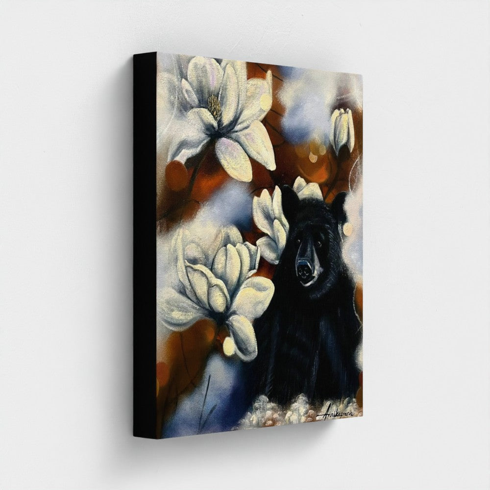 Feeling Small in a Big World — Canvas Print by Annikaprana. Close-up side view showing black 4 cm gallery wrap edges. Black bear with white magnolia flowers on canvas, 13×16″ (33×40 cm).
