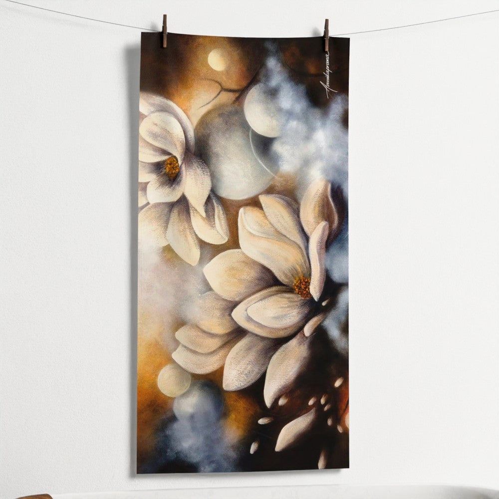Flourishing in the Light — Beach Towel by Annikaprana, hanging on a line showing full print. White magnolia flowers in warm golden light, 70×140 cm.
