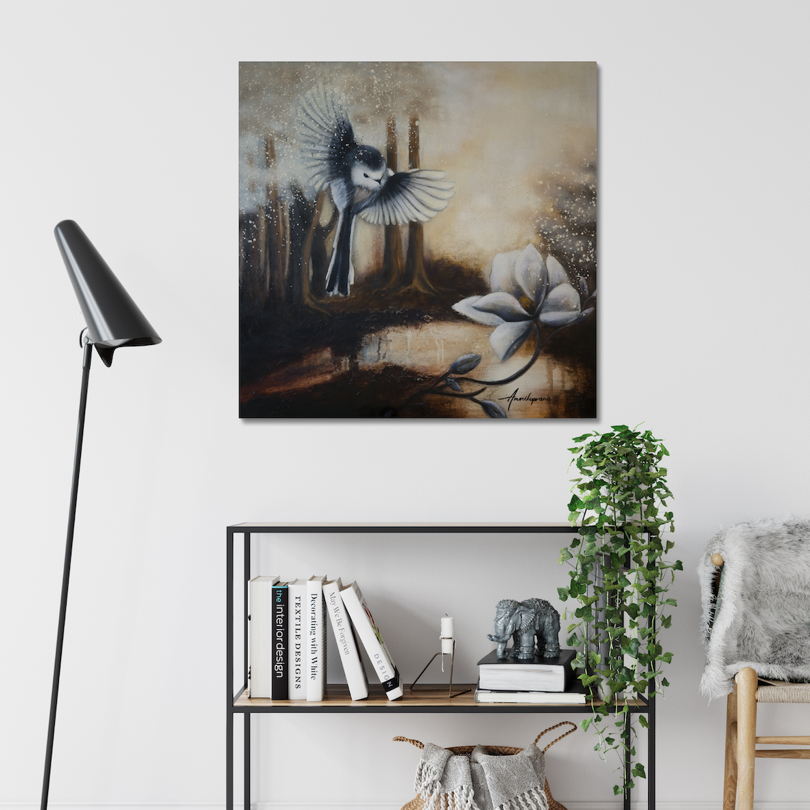 Sunshine After Rain 2026 — Canvas Print by Annikaprana. A long-tailed tit in flight above a white magnolia in a misty golden forest. Displayed above a shelf in a Scandinavian interior. Giclée on canvas, black 4 cm gallery wrap, ready to hang.