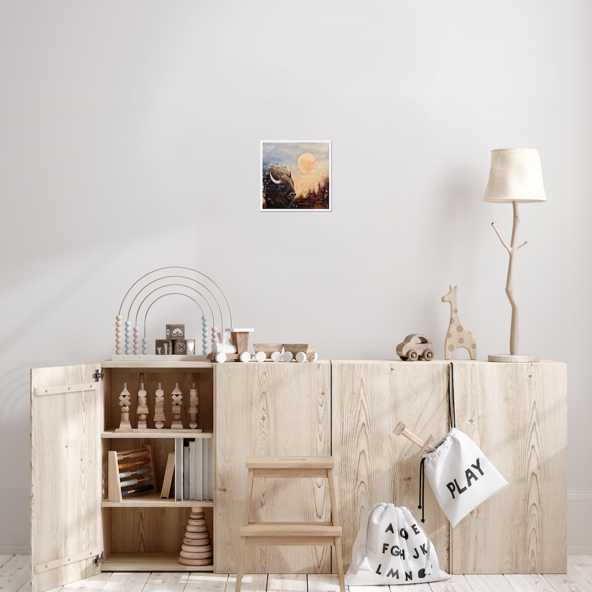 Moonlight Reflections — Fine Art Print by Annikaprana. A majestic bison beneath a glowing golden moon in a dark, mystical landscape. Giclée on Hahnemühle German Etching 310gsm, white border, 12×12″ (≈30×30 cm). Displayed on a grey wall in a Scandinavian children's room.