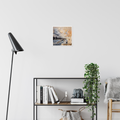 New Horizons Ahead — Fine Art Print by Annikaprana. A white bird soaring above a dramatic coastal landscape in warm amber and stormy grey tones. Giclée on Hahnemühle German Etching 310gsm, white border, 12×12″ (≈30×30 cm). Displayed on a white wall in a Scandinavian living room with a black floor lamp and open bookshelf.