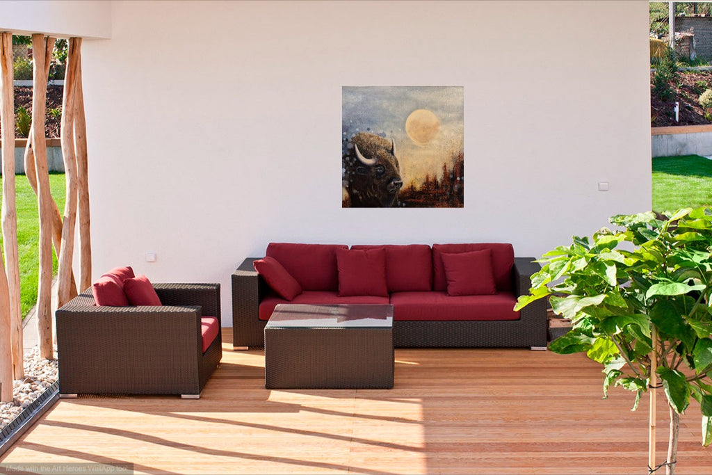 Moonlight Reflections 2026, original painting by Annikaprana. Oil on canvas depicting a solitary bison beneath a full moon in a misty nocturnal landscape, displayed above a red sofa in a contemporary living room. Original, 1/1, sold.